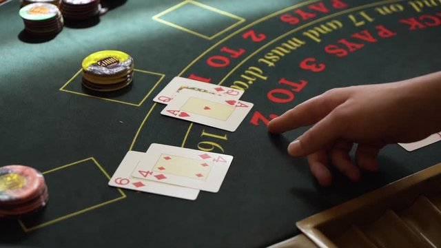 Slow Motion shot of croupier revealing a blackjack on poker table