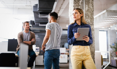 Beautiful business woman holding tablet computer in office