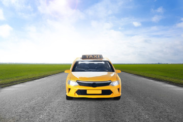 Yellow taxi car on asphalt highway outdoors