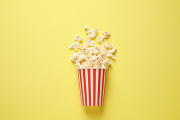Delicious popcorn on yellow background, top view