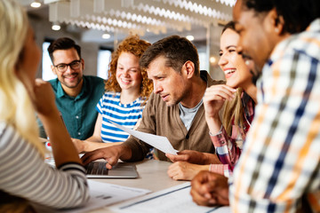 Successful group of designers, business people at work in office