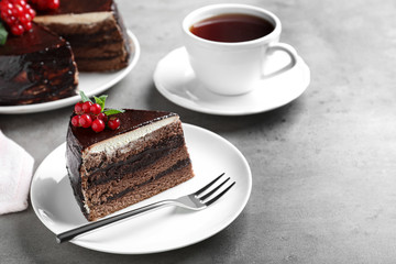 Tasty chocolate cake with berries on grey table