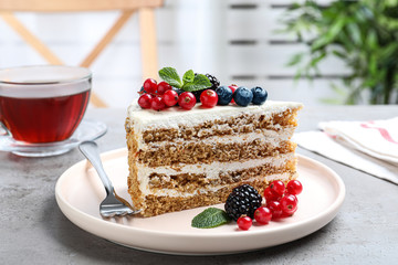 Tasty cake with berries on grey table indoors
