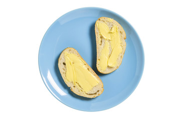 Ciabatta bread and butter on blue plate isolated on white. Directly above.