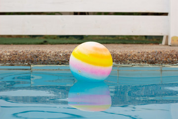 ball floating in water surface swimming pool side space outside yard in garden