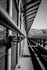 Metal border fence preventing crossings and increasing safety, showing border issues