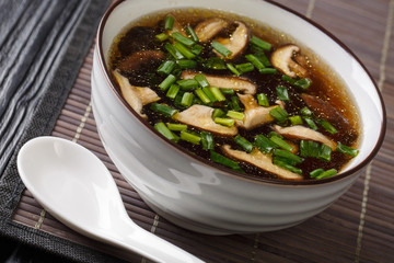 Dietary soup with shiitake mushrooms and green onions close-up in a bowl. horizontal