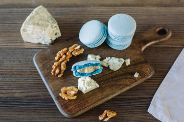 Cheese and walnuts with dessert on background