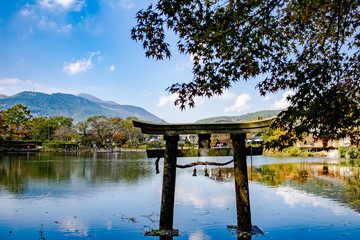 Kinrin Lake area or call in Kinrinko lake, one of landmark at Yufuin with background of leaf change colour and reflection of lake water.