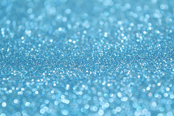 Baby blue glitter background. Selective focus. Beautiful sparkle abstraction. Glamour Bokeh Effect. For party, holidays, celebration.