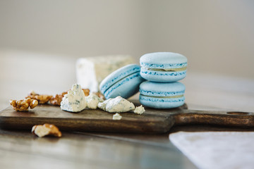 Delicious macaron on wooden board with ingredients
