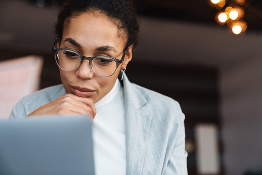 Image Of African American Businesswoman Working On Laptop In Office