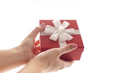 Female hands with red gift box on white background.Wide 16:9
