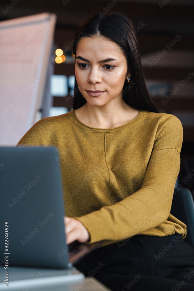 Sticker Image of young caucasian businesswoman working on laptop in office