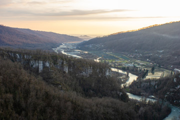 Fototapeta premium View of a mountain valley with a river at sunset. From the longest pedestrian bridge in the world in Sochi