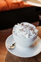 Viennese coffee on table. Drinks in cafe background.