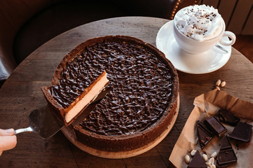 Chocolate cake cafe, nut cake with caramel. Coffee pause.