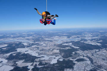 Skydiving. Tandem jump. Two men are having fun in the sky.