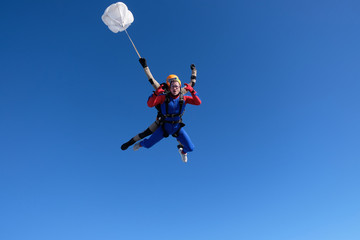 Obraz na płótnie Canvas Skydiving. Tandem jump. Two men are having fun in the sky.