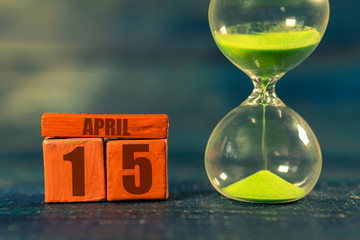 april 15th. Day 15 of month,Handmade wood cube with date month and day and hourglass with green...