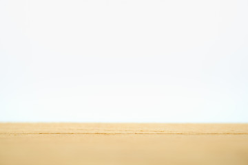 Empty wooden table top with white background and copy space use for montage product display or wallpaper.