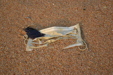 Medical respiratory mask dirty in the sand