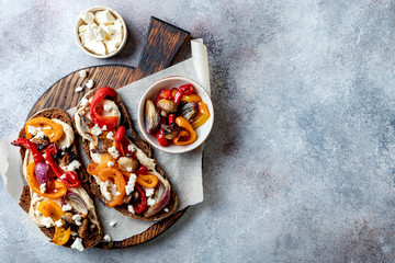 Roasted vegetables toast with hummus and feta cheese