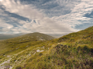 Fototapeta na wymiar High land in Connemara, county Galway, Nobody, Cloudy sky, green wild grass. Ireland.