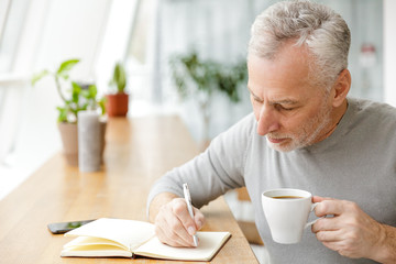 Businessman sit in cafe writing notes