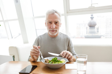 Senior grey-haired bearded businessman