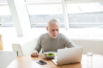 Senior grey-haired bearded businessman