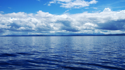 Obraz premium tropical island on the background of the sea and blue sky