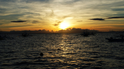 Obraz premium tropical island and fishing boats at sunset