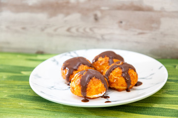 Profiterole with vanilla and chocolate sauce