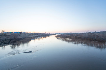 the nature of the spring flood the river ice trees water reflection