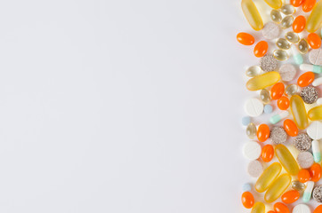 Assorted colorful tablets, pills, drugs on white background. Medication and healthcare concept.