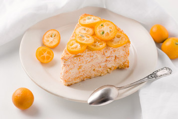 sweet cake decorated with kumquat slices on a white background close-up