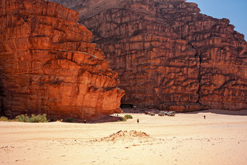 Tent of a Bedouin camp in the panorama of rocky mountains and red sand in the Jordanian desert of Wadi Rum.