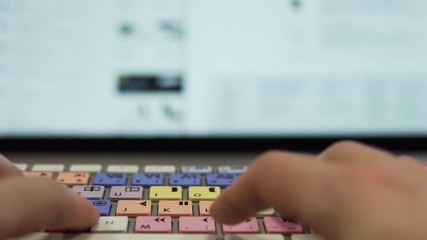 Slow Motion: Typing on Editing Keyboard in Front of Modern Display