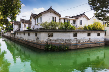 Fototapeta na wymiar White houses by the river in Pingjiang street, Suzhou old town, China