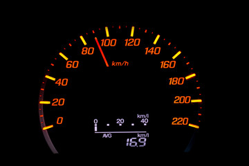 Close up of car speedometer with the needle pointing at  90 kmh on black blackground
