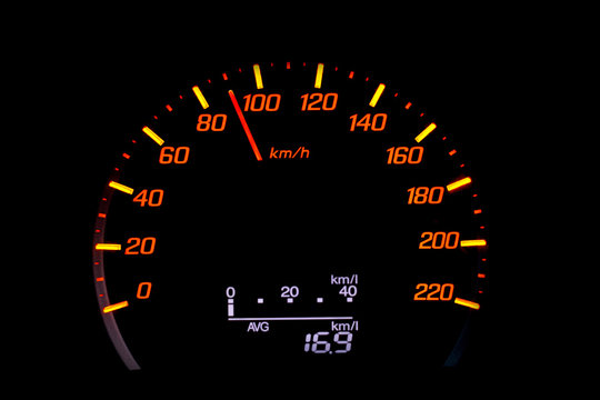Close up of car speedometer with the needle pointing at 90 kmh on black blackground