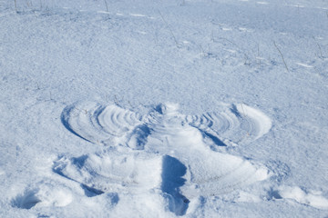 imprint of a man in the snow