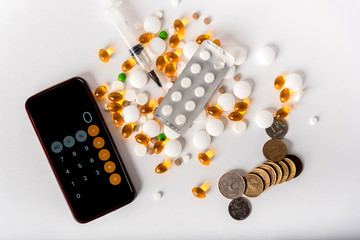 scattered pills of different shapes and colors on a white background