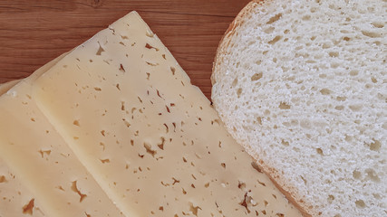 cheese and bread slices on a wooden kitchen board