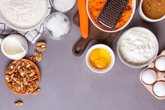 Baking Ingredients For A Carrot Cake Flour, Butter, Brown Sugar, Grated Carrots, Walnuts And Other