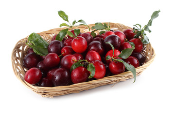 Red plums on wooden tray