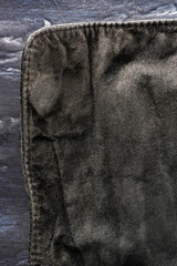 black structural background - old shabby stylish suede, reverse side, old fabric, textile. piece of...