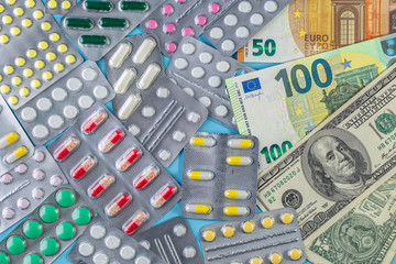 Different medicines and money. The rising cost of health care. Medical pills on money background as...