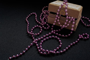 Small cardboard jewelry box with pink beads